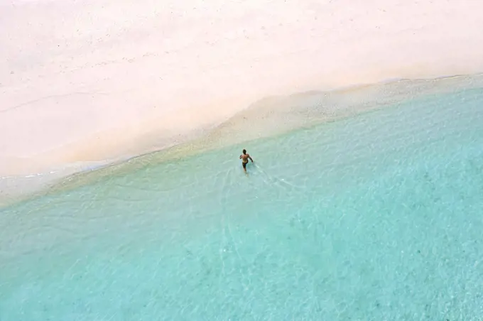 Aerial view of lone man at the beach
