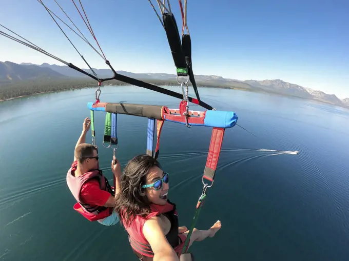 A woman enjoys parasailing in South Lake Tahoe, California.
