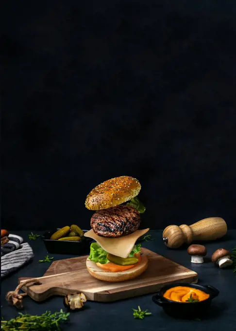American burger on wood. Food styling. Food levitation