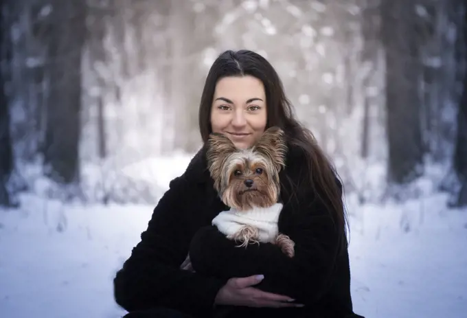 Winter portrait of a girl with her best friend - a dog