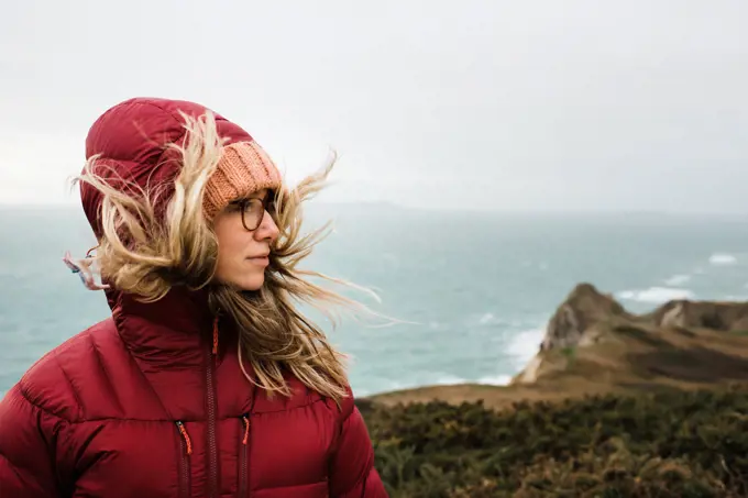 portrait of a woman hiking along the Jurassic coast in England