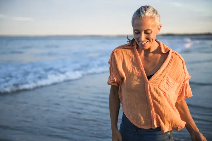 Gray Haired Woman enjoying the beach at sunset