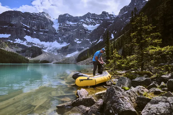 A man prepares for a rafting trip across Cirque Lake in Banff, Alberta