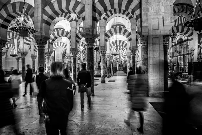 tourists in the mosque of cordoba in spain