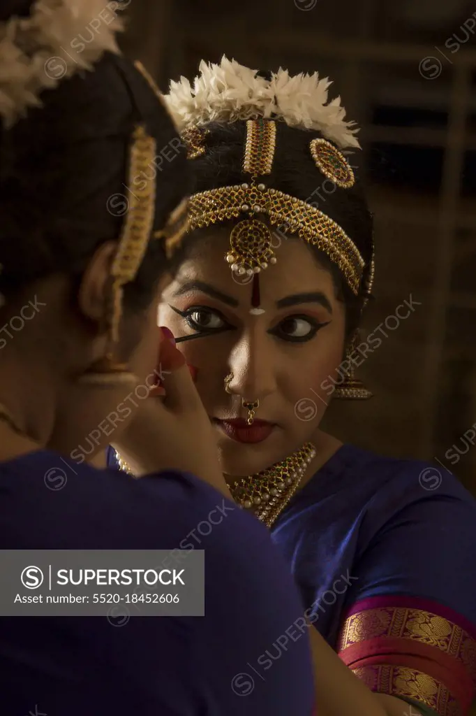 Applying Kajal In Her Eyes