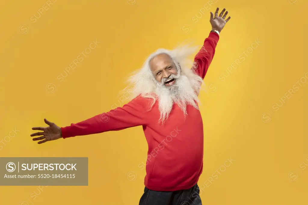 A HAPPY OLD MAN RAISING HANDS IN HAPPINESS