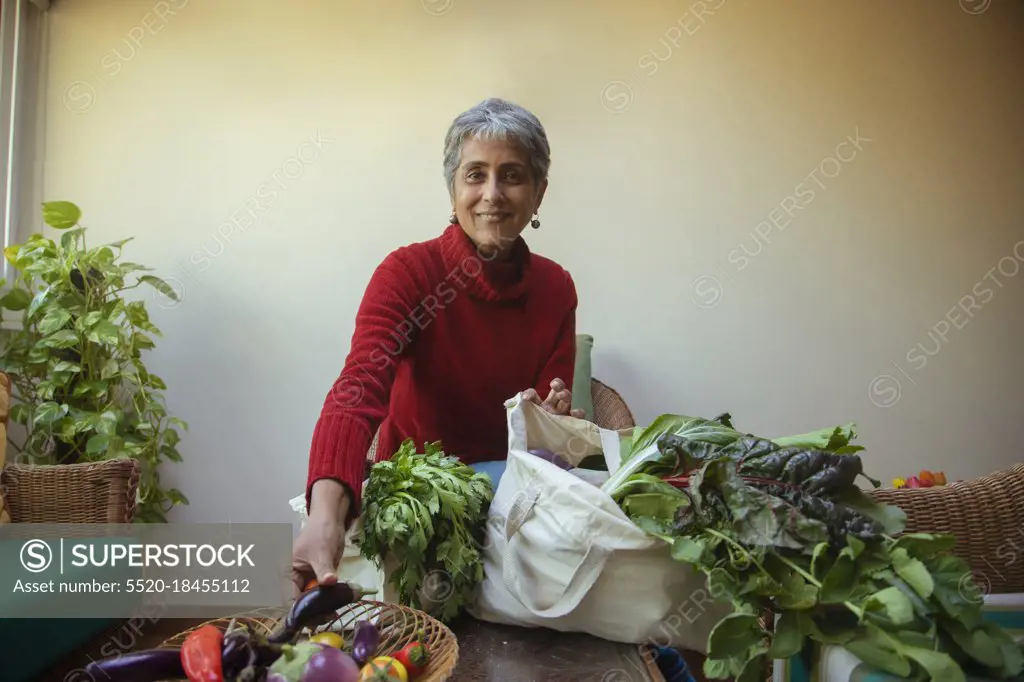 An urban farmer segregating her harvest in baskets 