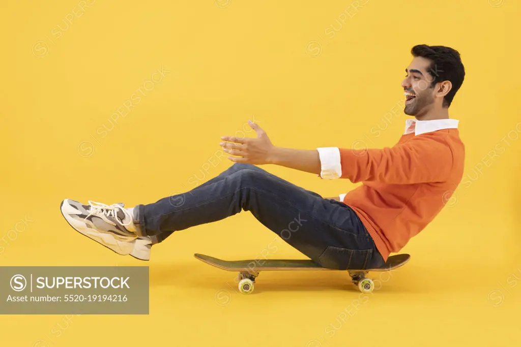 Portrait of a happy young man having fun while skating 