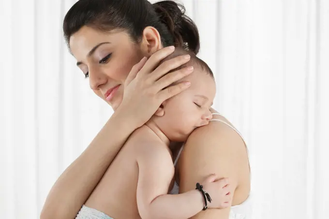 Mother holding a sleeping baby