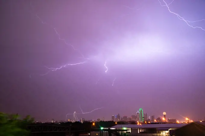 The sky is lit up purple over Dallas during a summer thunderstorm