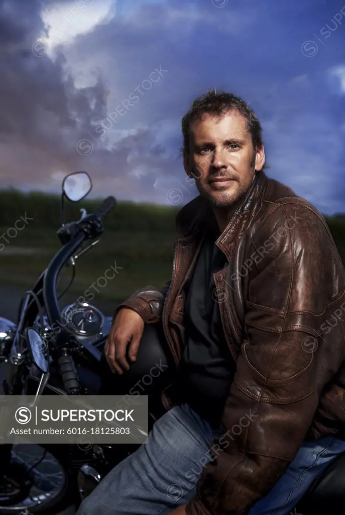 Portrait of a man sitting on his motorbike 