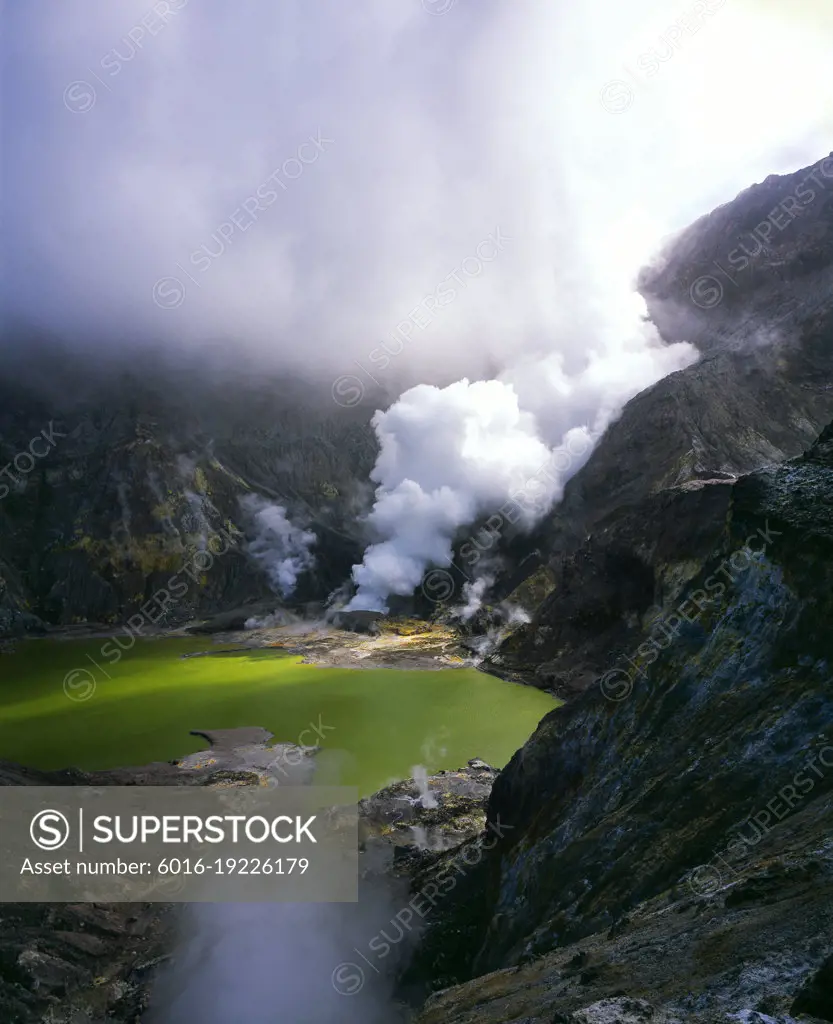 Crater Lake in crater of live volcano and steam rising - White Island