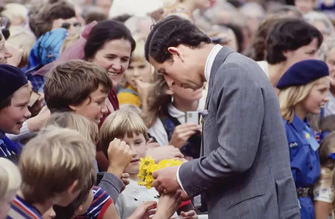 Prince Charles talking to children in crowd and accepting flowers - Royal Tour New Zealand - 1983