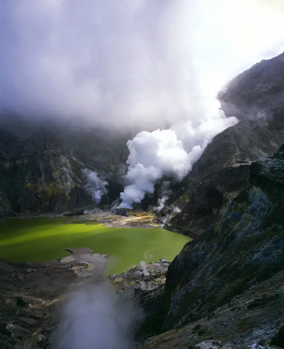 Crater Lake in crater of live volcano and steam rising - White Island