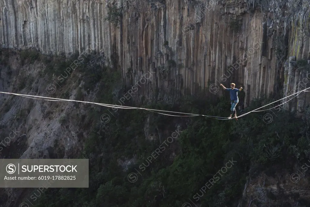 One person walking on a highline at "El Gato" canyon in Meztitlan