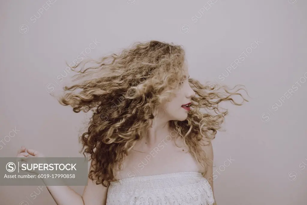 portrait cute blonde girl with curly hair