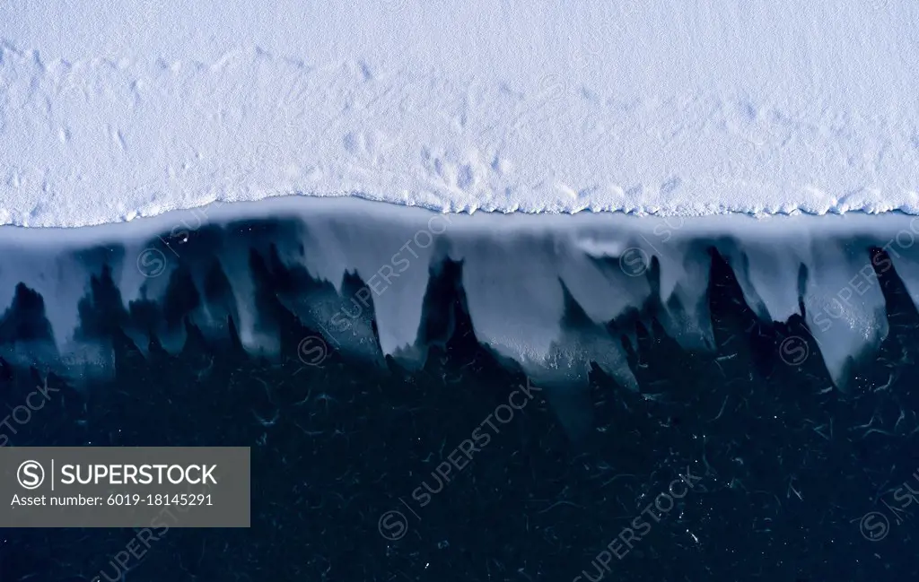 Frozen glacier shore in snow
