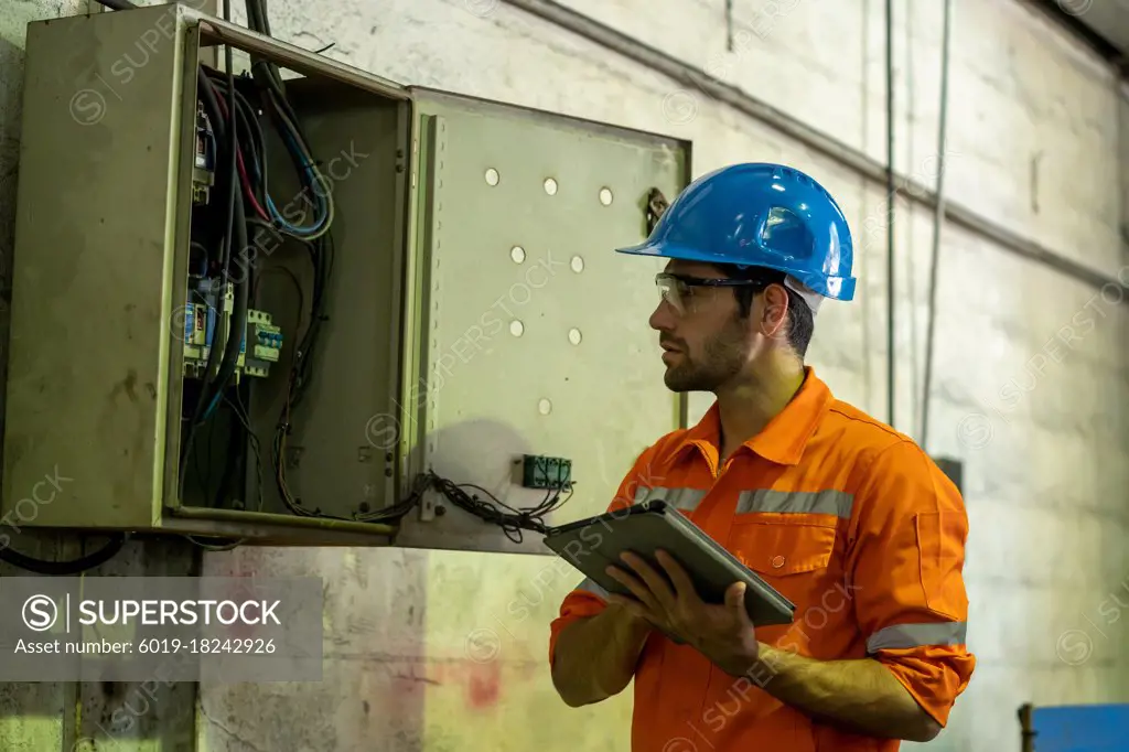 Engineer or factory worker using digital tablet checking