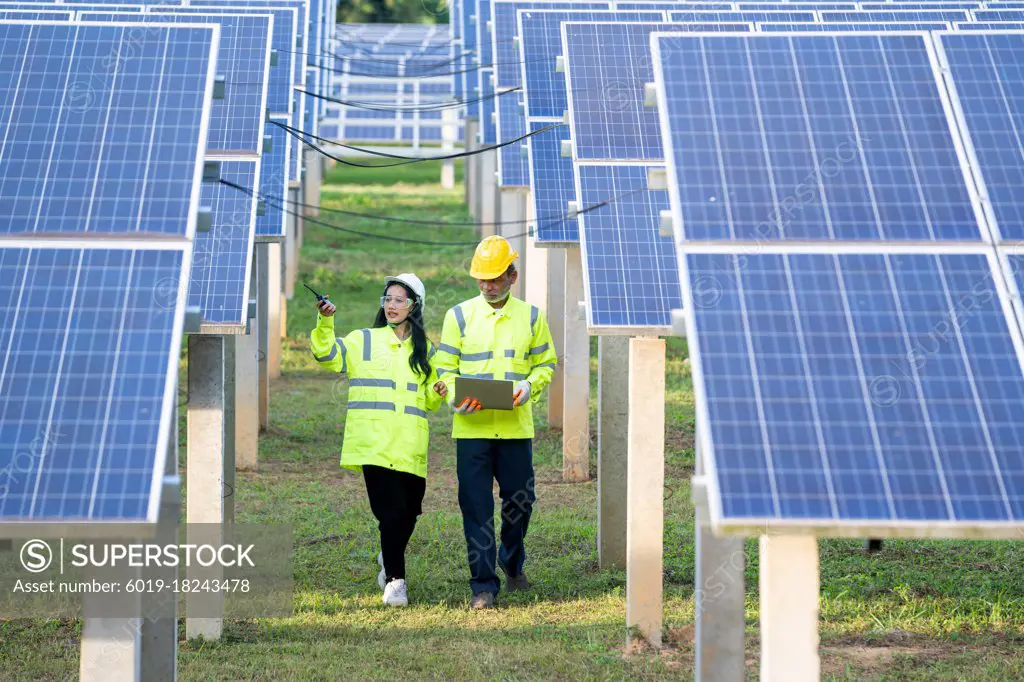 Engineer and Technician checking equipment in solar panels