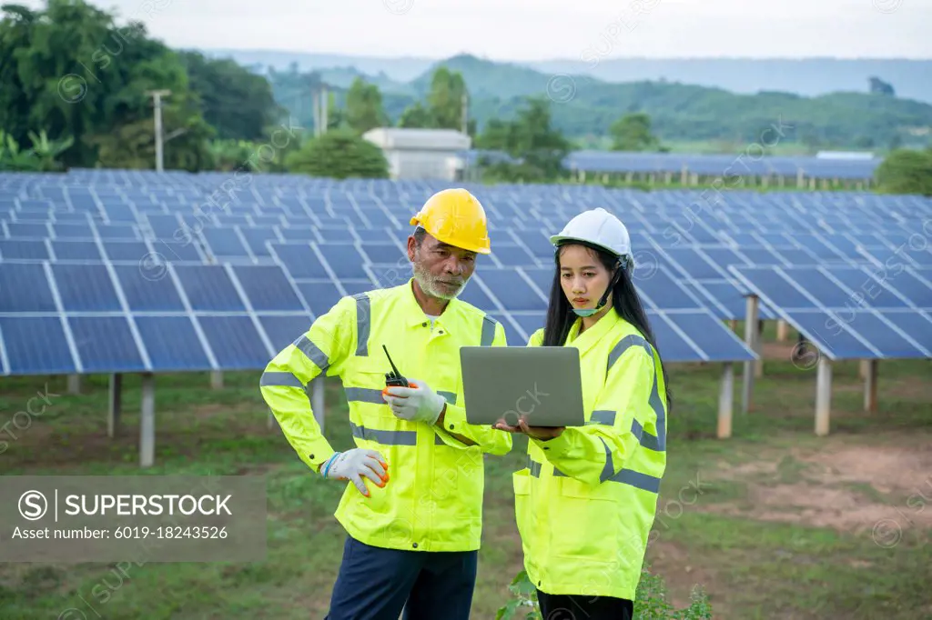Solar power plant,Engineer working with tablet computer