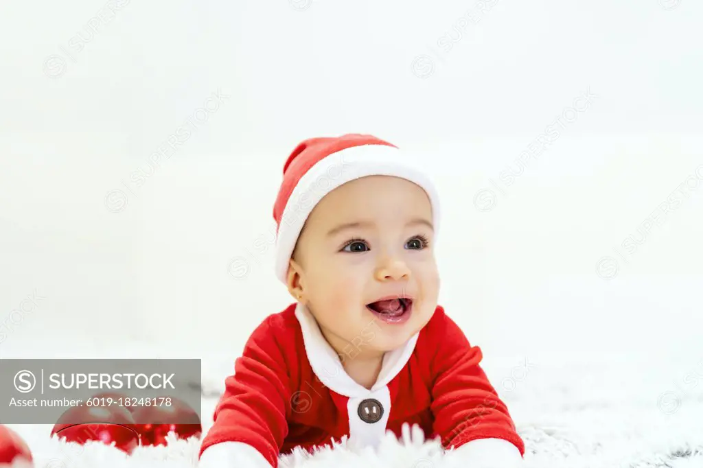 beautiful baby dressed as santa claus at christmas