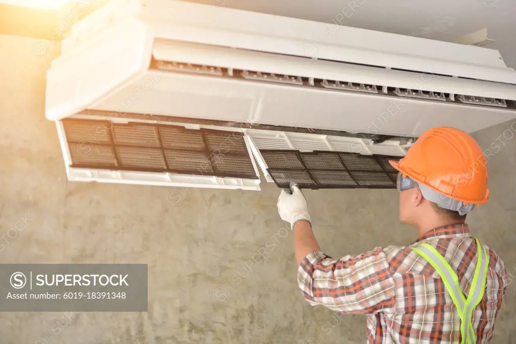Air conditioner repairmen work on home unit