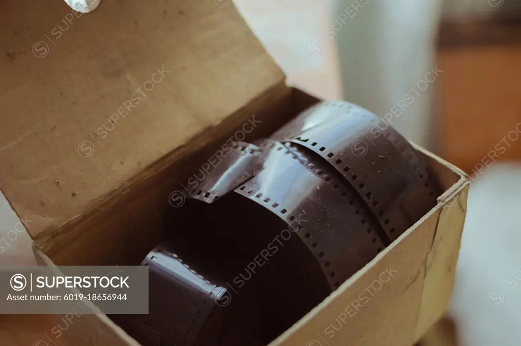 Old cardboard box with large reels of retro photo films