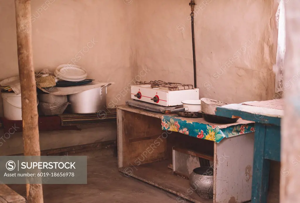 Old abandoned kitchen with wooden table and utensils