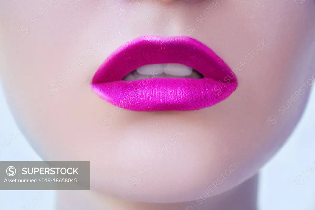 Pink glittery lipstick on lips