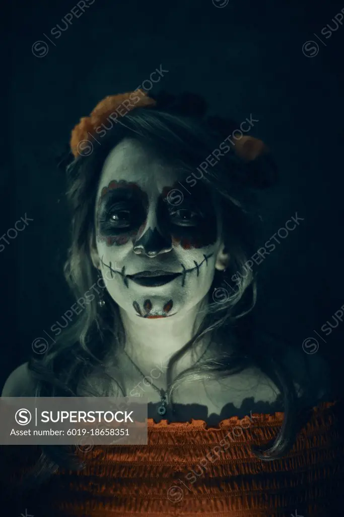Happy woman at celebration make up of day of dead