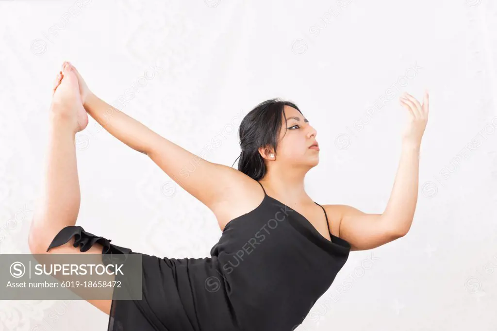 Young woman practicing dance steps to develop her talent.