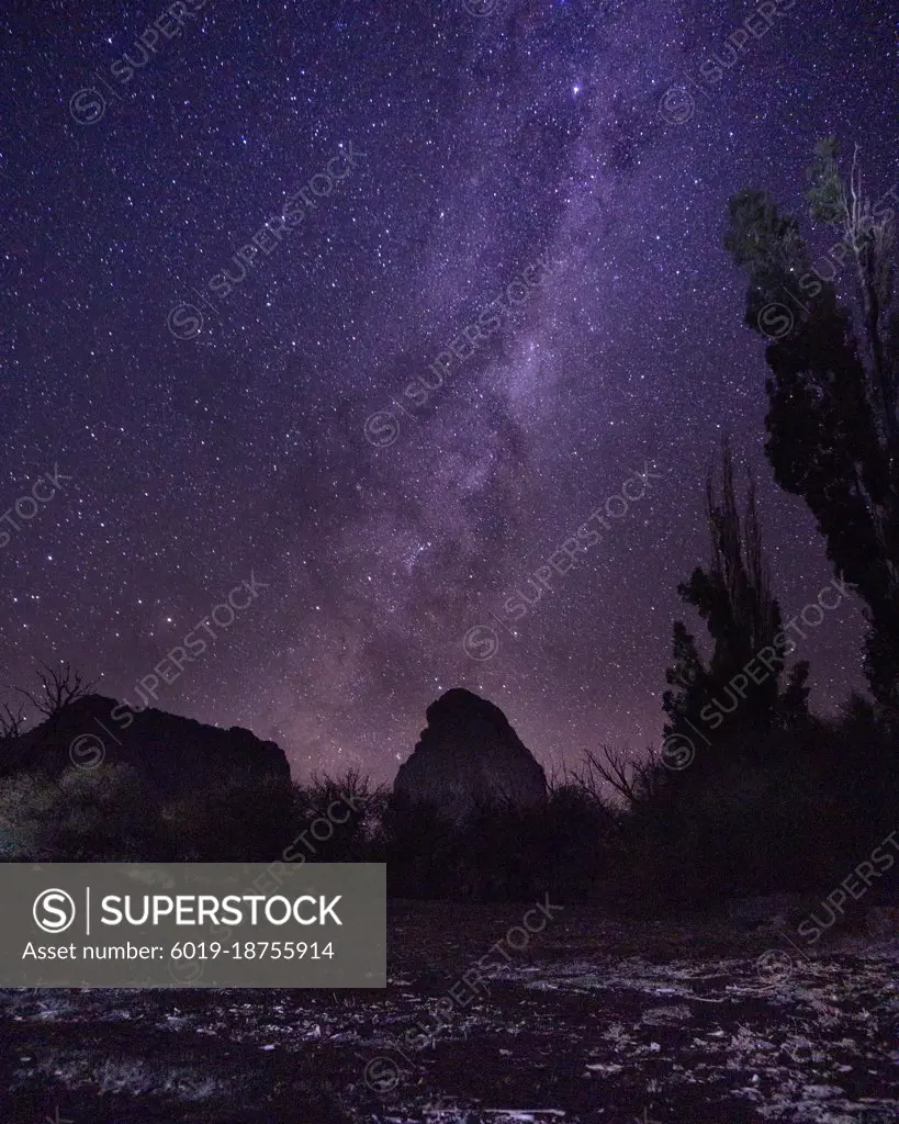 Milky way stars falling in a rock formation in patagonia