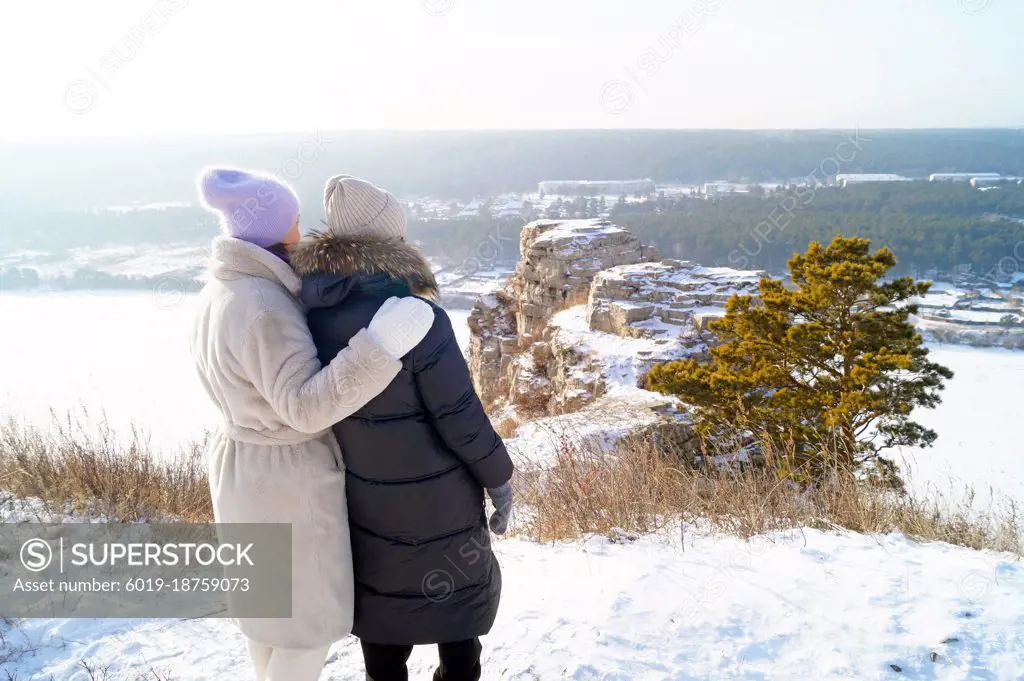 Women hugging each other stand in front of White Rocks