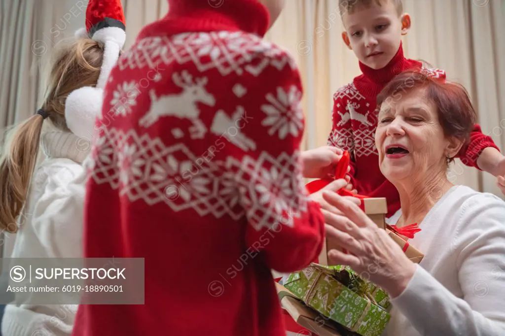 children receive gifts from grandmother