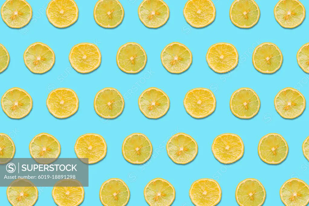 Lemon Slices on a Blue Background in a Pattern