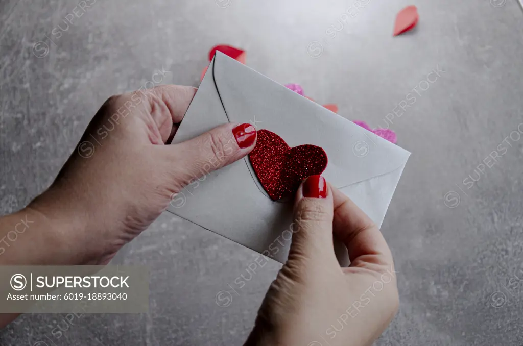 letter with heart in hand