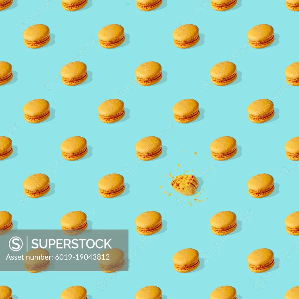 french delicacy - macaroons with shadow on blue background, seam