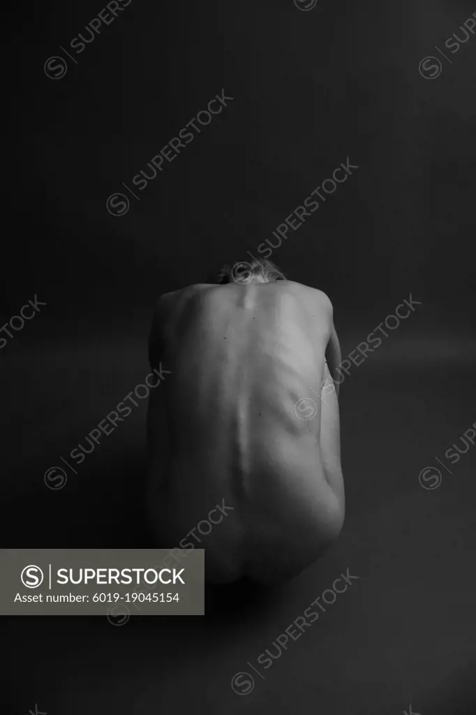 Black and white photo of body parts,yoga poses of a naked female body