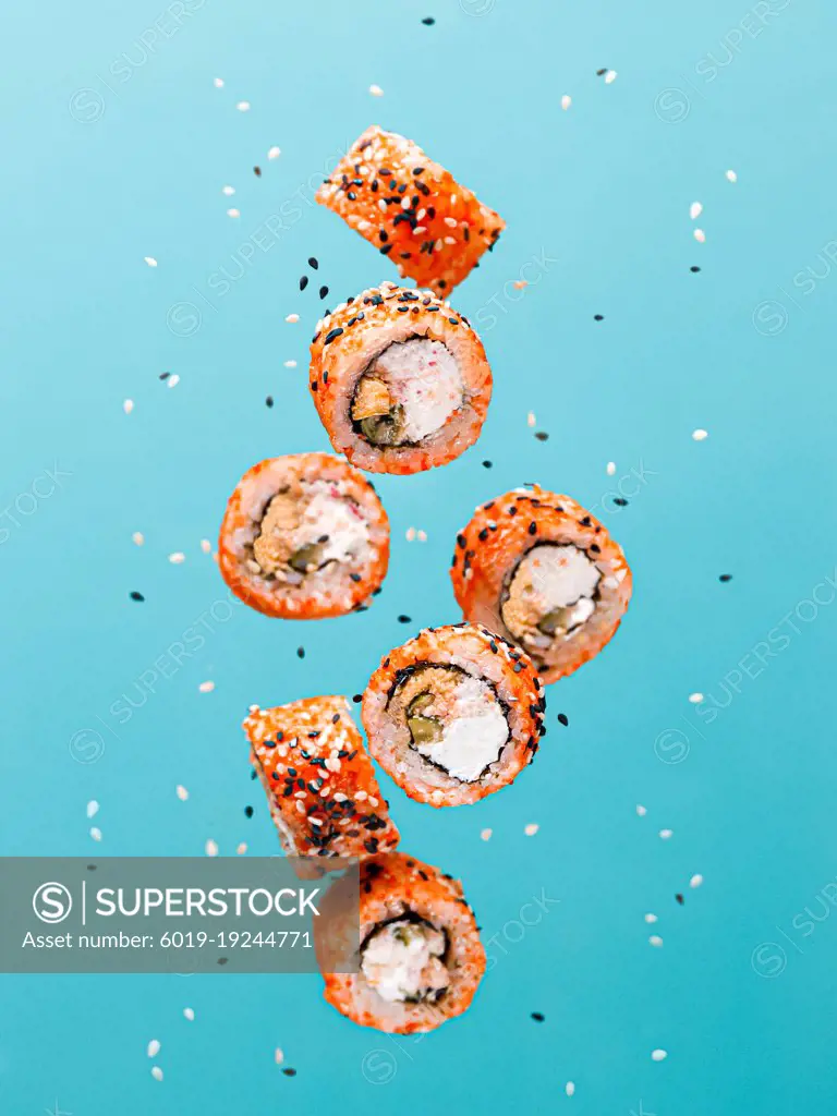concept of flying sushi and rolls with salmon levitation