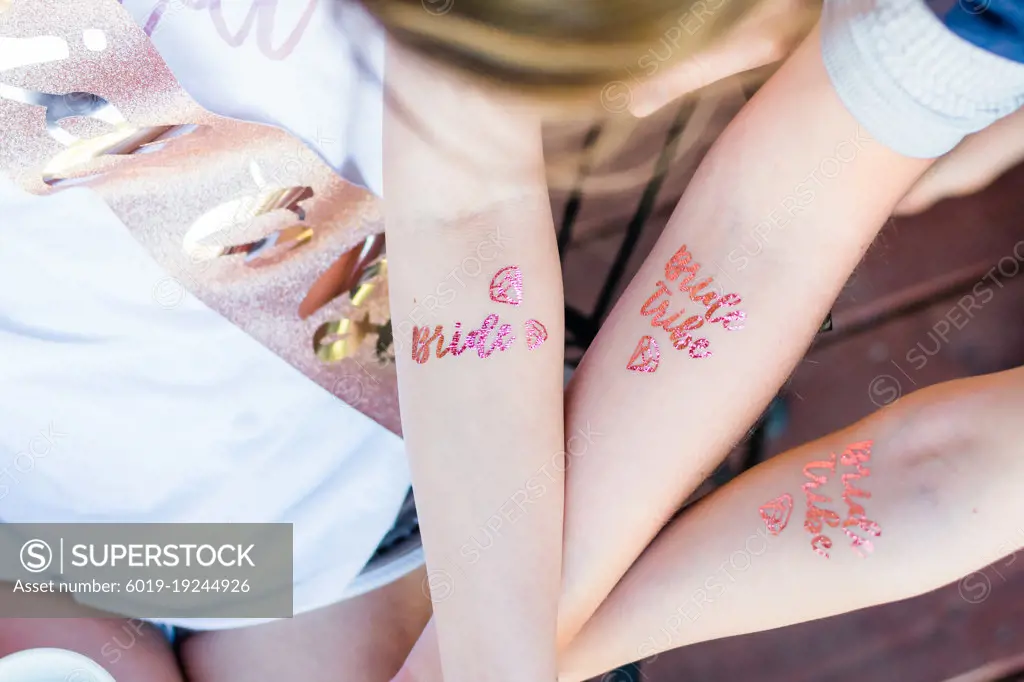 Girls at a bachelorette party with bride tribe tatoos.