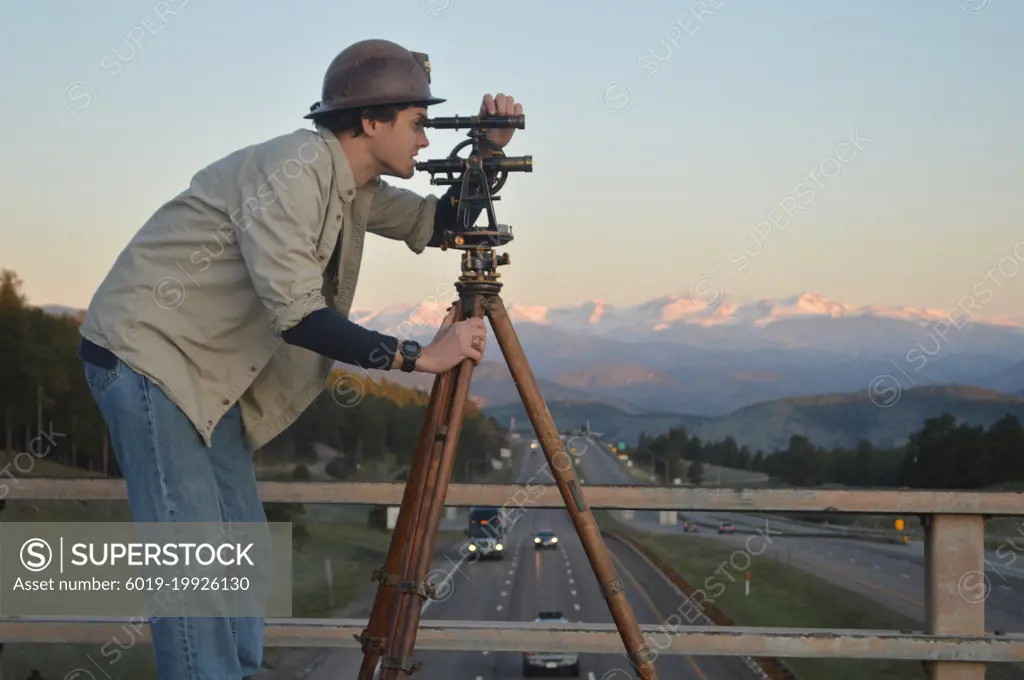 Engineer surveying highway construction, I 70, Colorado