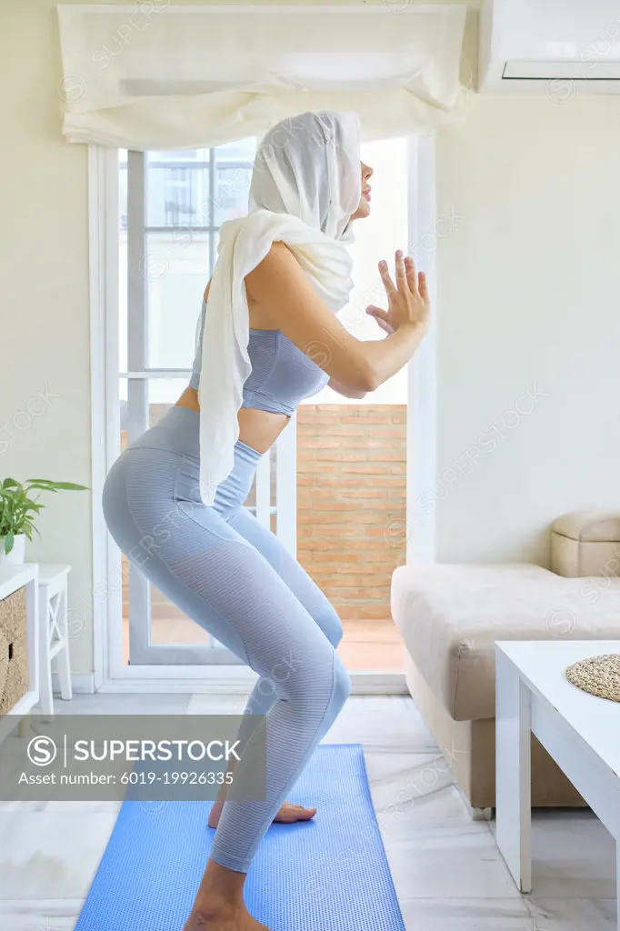 arab young woman doing sports at home with hijab