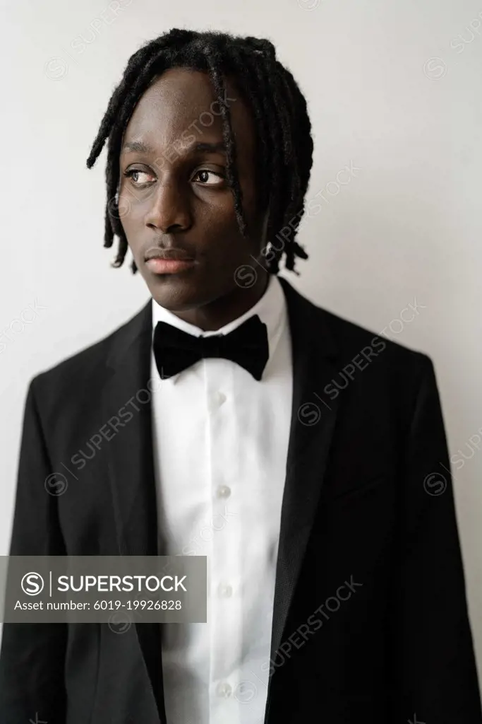 Portrait of the black man with dreadlocks wearing a suit