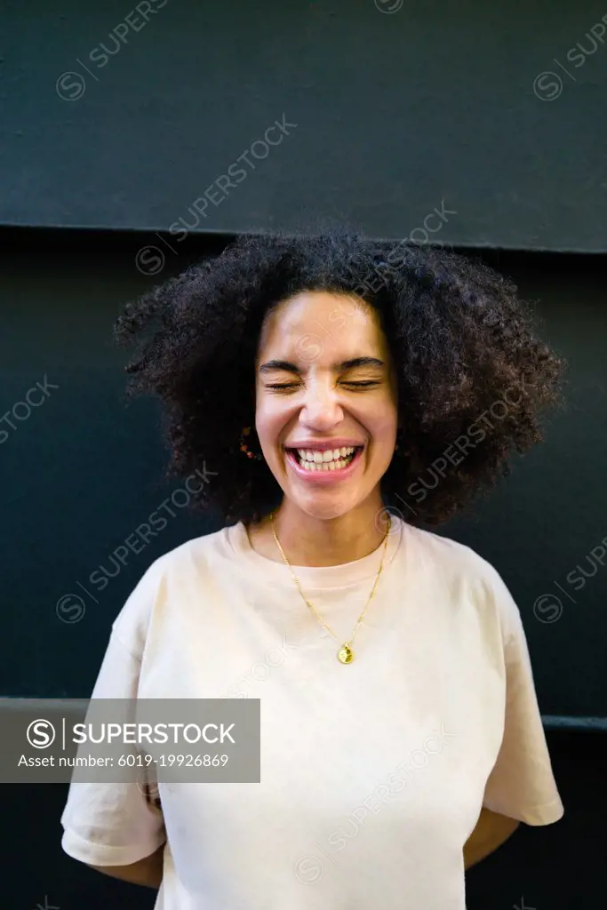 Portrait of a young woman  with curly hair on the black backgrou
