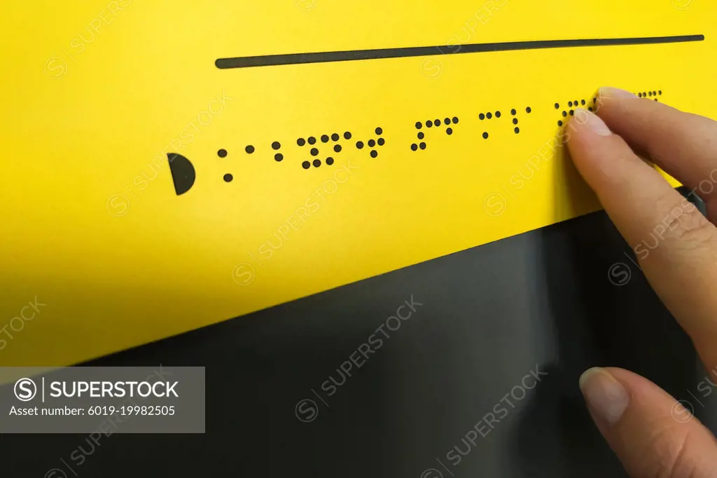 Woman hand reading braille text