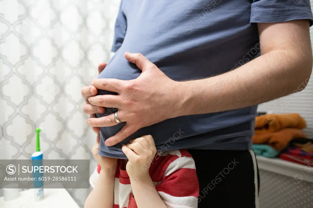 Playful Dad with Preschool Age Son Standing in Bathroom