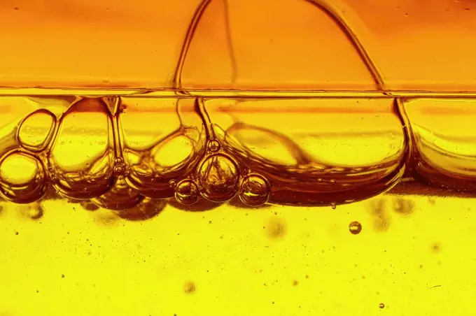 A viscous yellow liquid with air bubbles