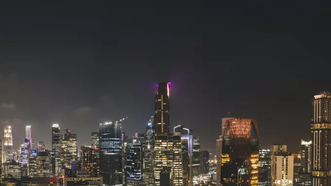 Panorama cityscape of Singapore city skyline at night from a rooftop viewpoint.