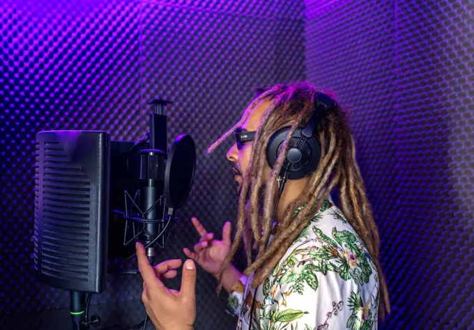 Rasta recording his song in a recording studio