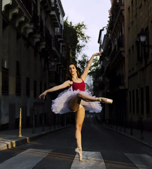 Portrait of a young ballerina on pointe shoes in the street